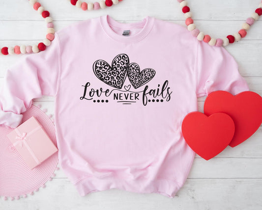 Love Never Fails Light Pink Sweatshirt